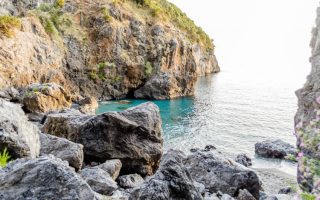 Spiaggia rocciosa con mare blu,a Scalea